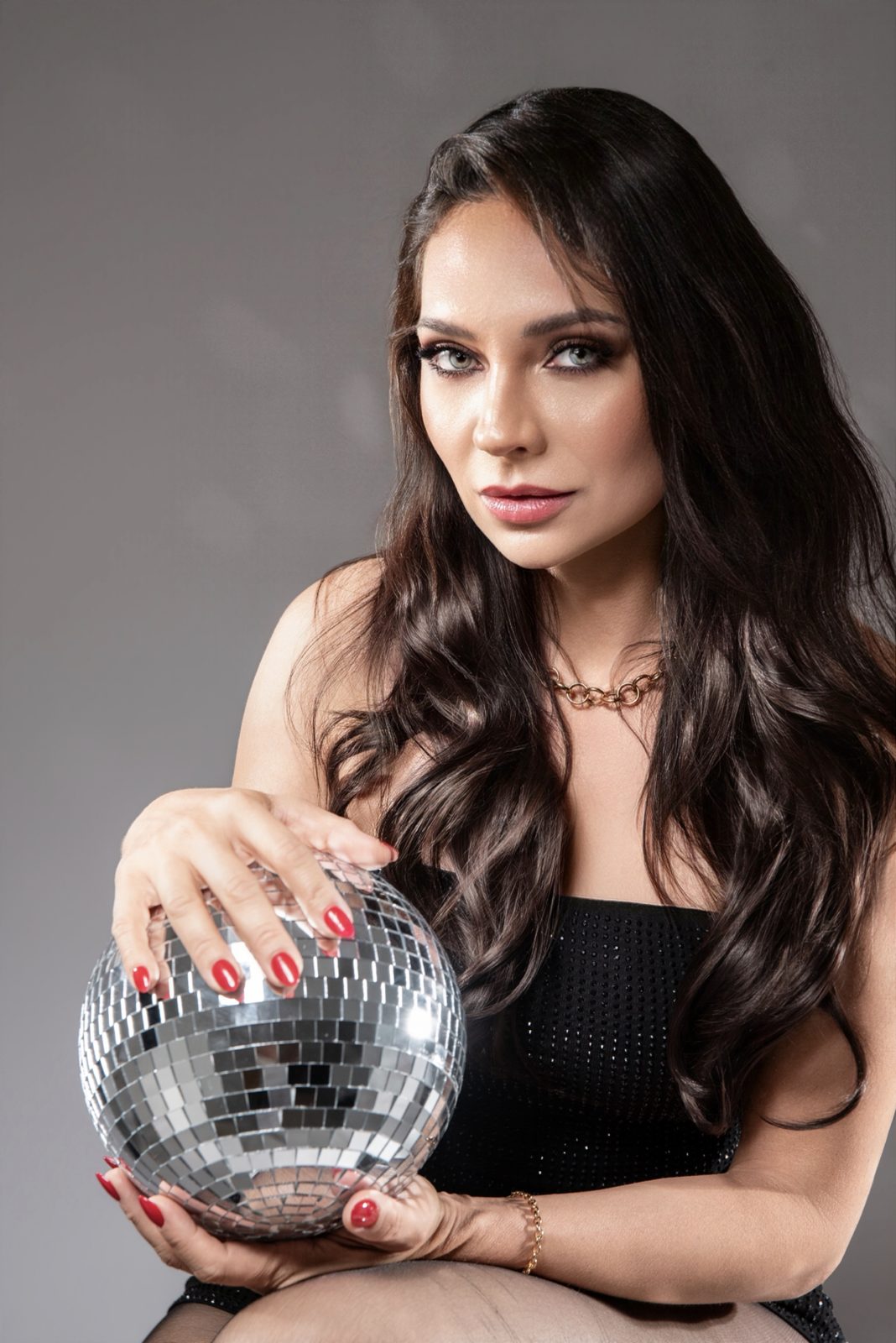 Florence Vixen holding a mirrored disco ball